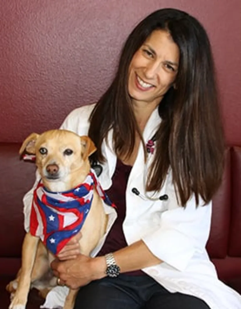 Dr. Monika Scott holding a dog 